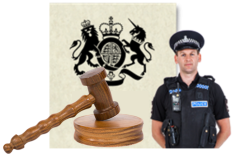 A court gavel. A gavel is the hammer used in the court by the judge. Next to the gavel is a police officer standing straight with arms behind his back. Behind the gavel and the officer is a document. 