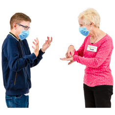 Two people communicating using sign language. They are both wearing face masks.  