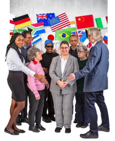 A group of happy people surrounding a woman, using their arms to form a circle around her. Behind the group are many different countries national flags.  